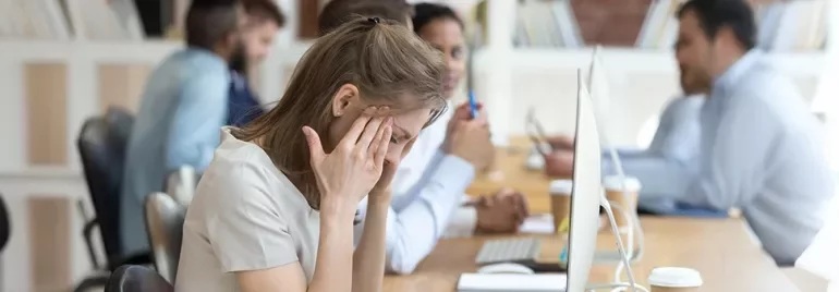 An employee stressed out from lacking workplace flexibility in the office.