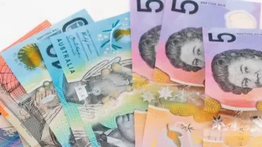 A stack of Australian dollar banknotes in various denominations.