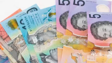 A stack of Australian dollar banknotes in various denominations.
