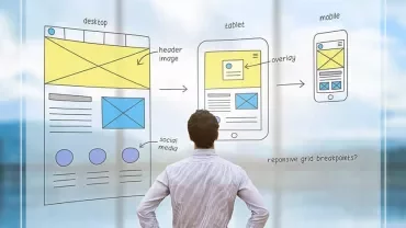 Person looks at design sketches on transparent board.