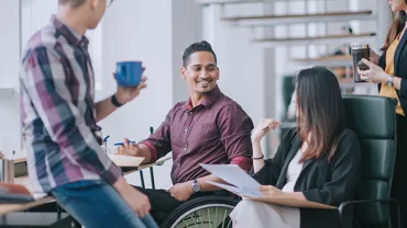Diverse group of colleagues having a casual meeting in an office.