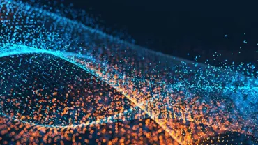 Abstract image with swirling blue and orange particles against a dark background.