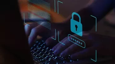 Hands typing on a laptop with digital lock and password symbols overlay.