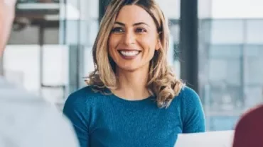 Woman smiling during a business meeting.