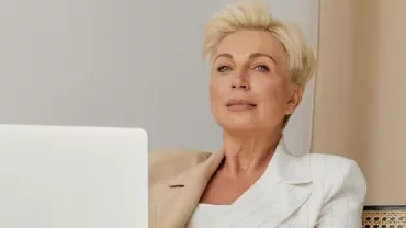 Woman-Smiling-While-Using-a-Laptop. Photo by Darina Belonogova via Pexels