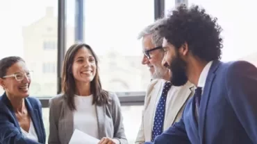 A handshake between business colleagues in an office, illustrating a moment of agreement and professional connection.