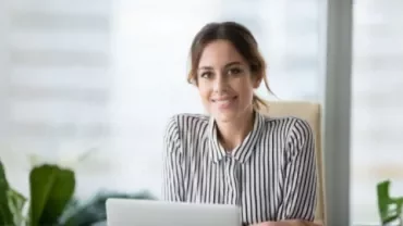 A professional smiles showing confidence in asking for a pay rise