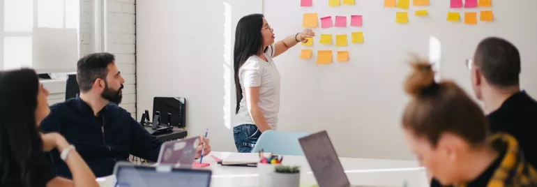 Team brainstorming session with sticky notes on the wall.