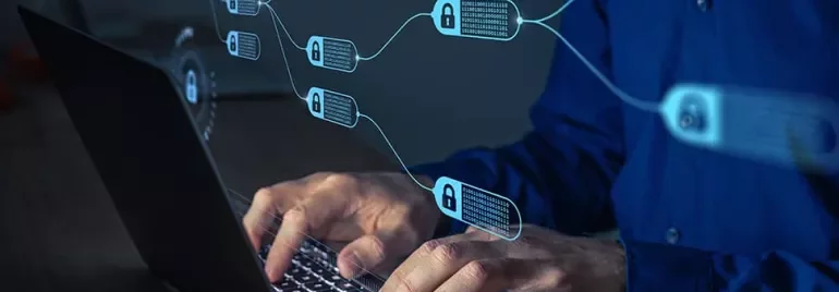 Person typing on laptop with digital blockchain network overlay.