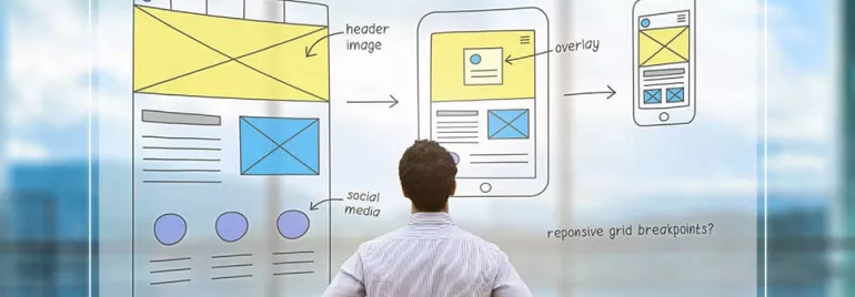 Person looks at design sketches on transparent board.