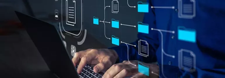 Person working on a laptop with digital file and folder icons.