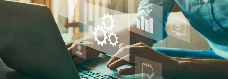 Person typing on laptop with digital icons of gears, charts, and graphs.