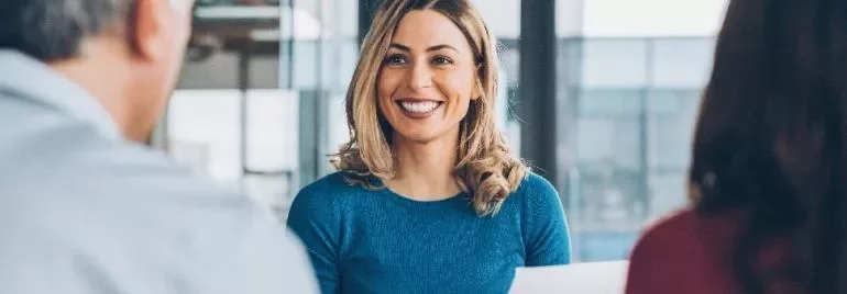 Woman smiling during a business meeting.