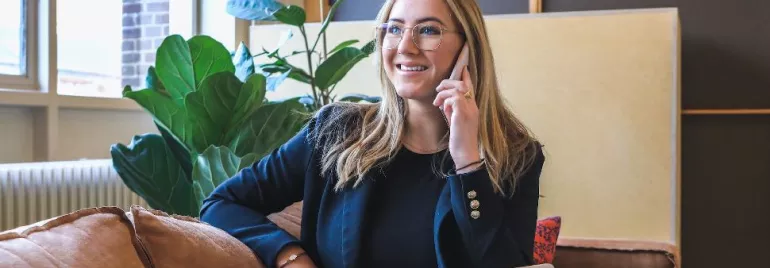 Woman-Smiling-While-Using-a-Laptop