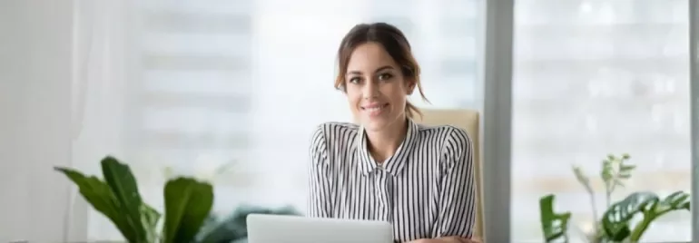 A professional smiles showing confidence in asking for a pay rise