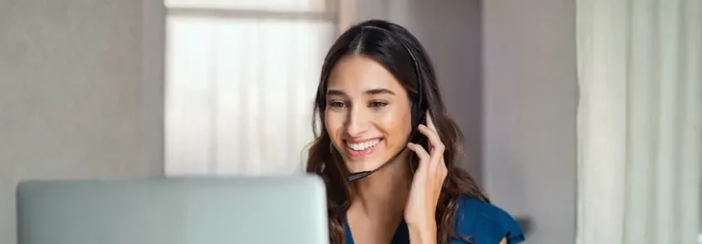 A woman with a headset speaks on the phone, representing career growth opportunities for top talent retention.