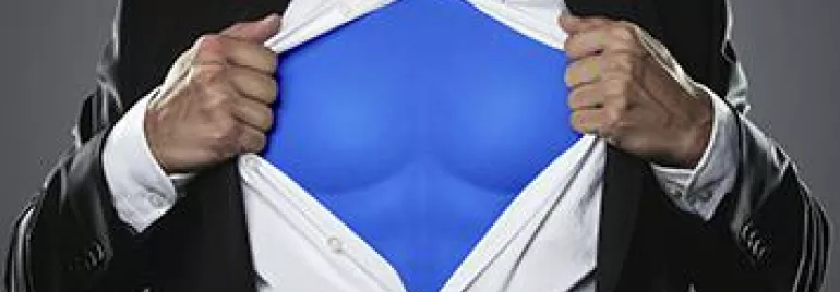 Man in a suit revealing superhero outfit underneath.