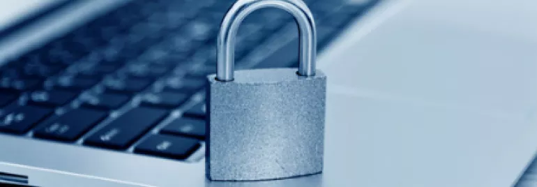 Padlock on a laptop keyboard symbolizing data security.