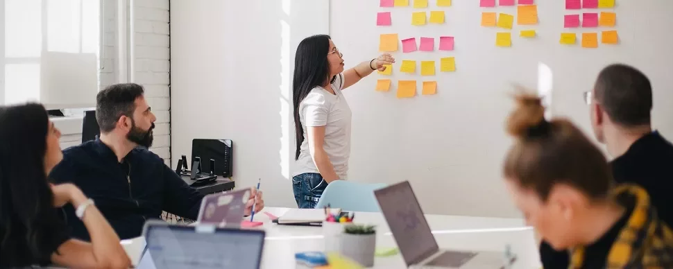 Team brainstorming session with sticky notes on the wall.