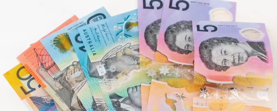 A stack of Australian dollar banknotes in various denominations.