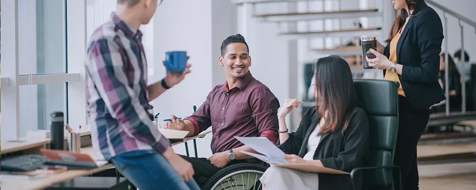 Diverse group of colleagues having a casual meeting in an office.