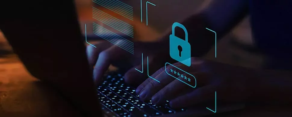 Hands typing on a laptop with digital lock and password symbols overlay.